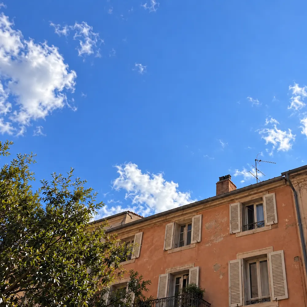 Architectural shot with all overhead wires removed, showcasing an immaculate gradient sky and crisp roof contours.